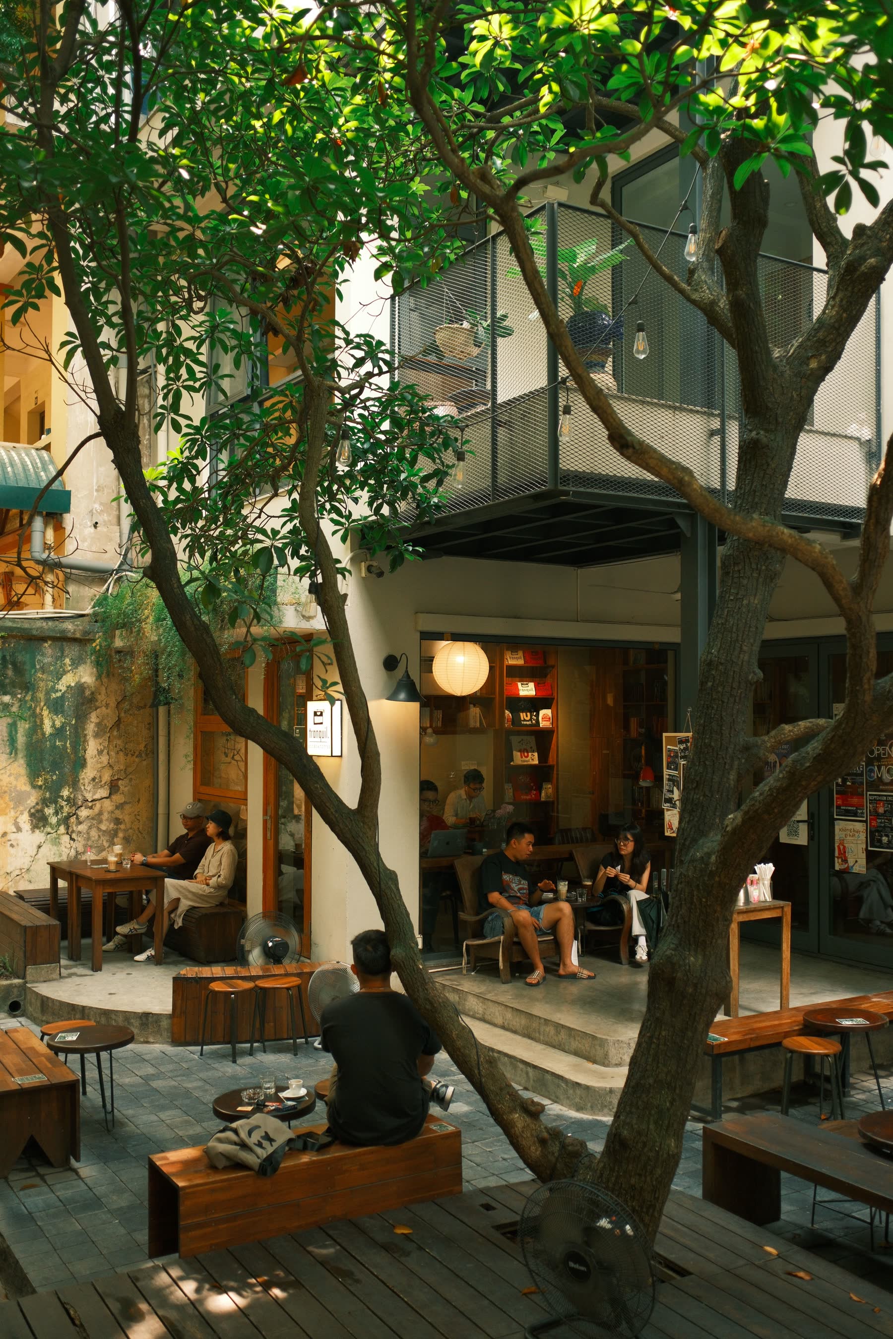 A quiet cafe courtyard with people hanging out