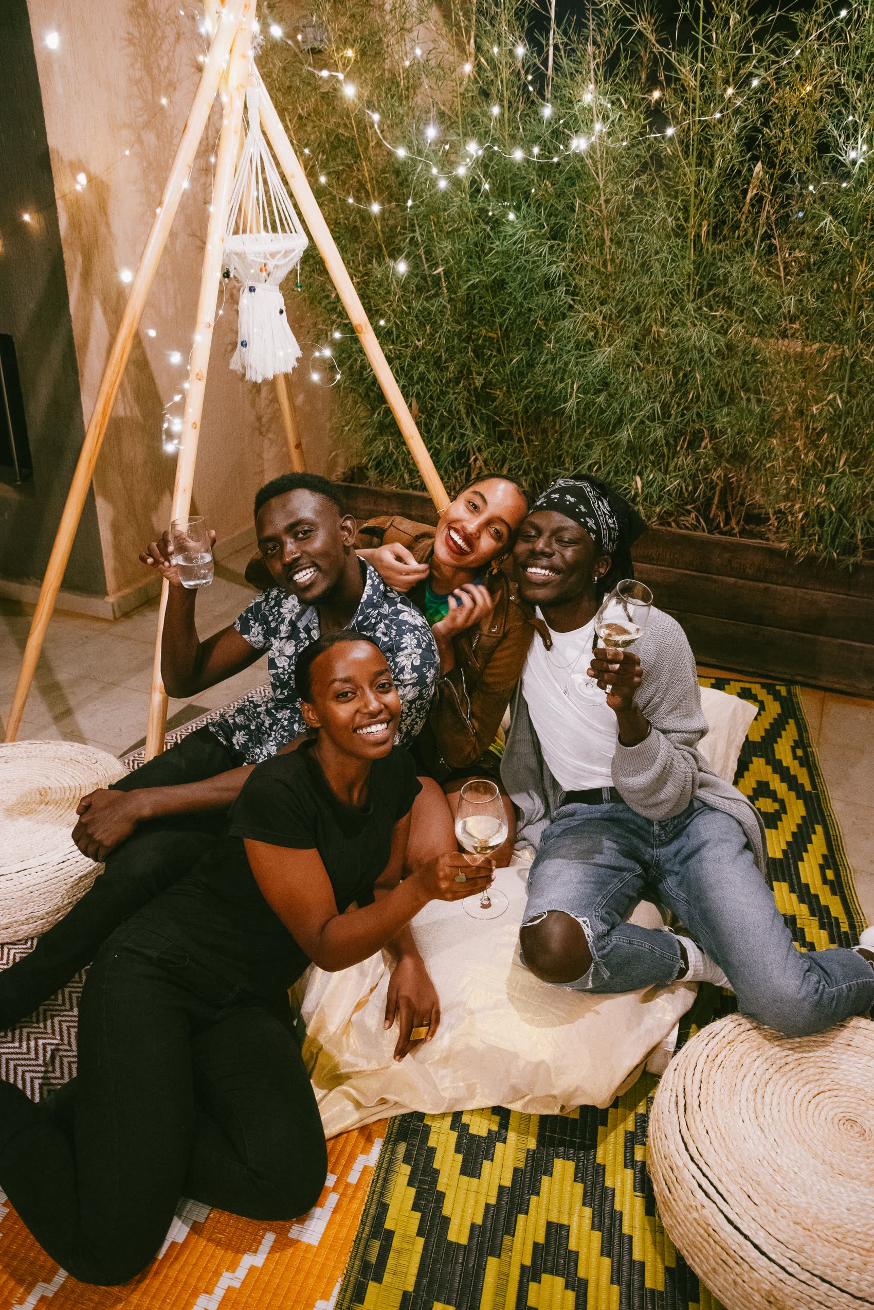 Friends hanging out together under string lights